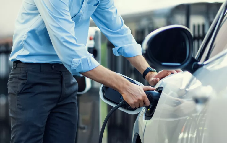 Man charging an EV