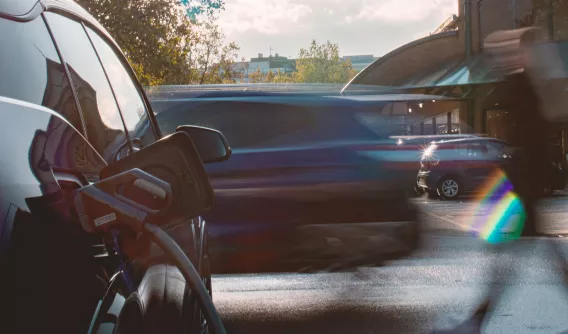 Black EV car being charged