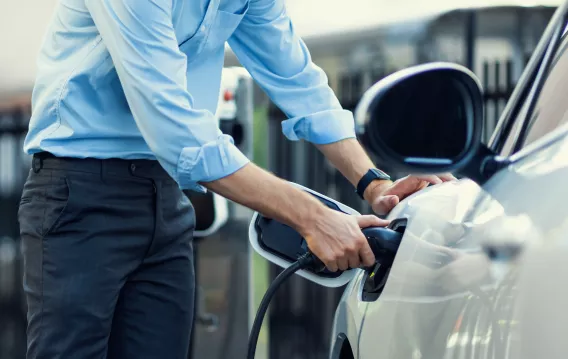 Man charging an EV