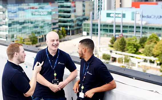 three Equans employees having a conversation