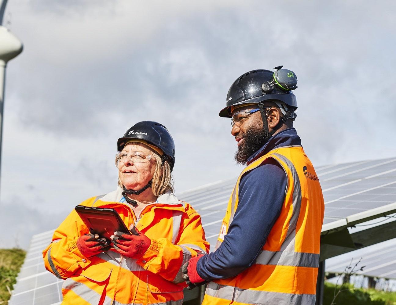 Two Equans renewables employees in ground mounted solar field