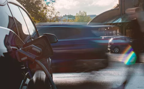 Black EV car being charged