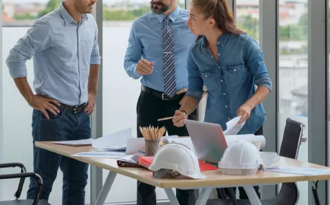 Engineers discussing on project in office.