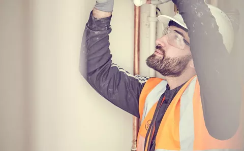 An equans employee checking a boiler