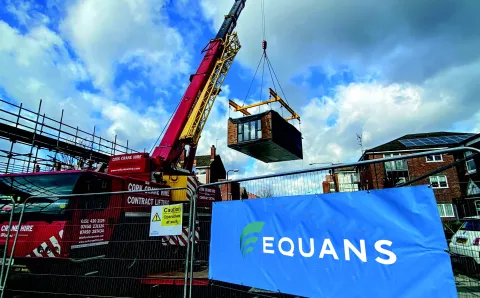 A crane delivering an off site manufactured modular housing solution