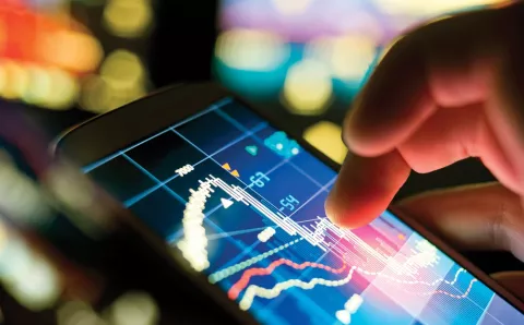 A persons finger touching a digital screen with data on it