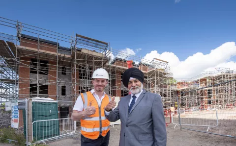 Simon Hoult, EQUANS Project Manager, and Councillor Bhupinder Gakhal, City of Wolverhampton Council Cabinet Member for City Assets and Housing, in front of the new council homes at Heath Town