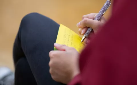 Student writing learnings about air pollution