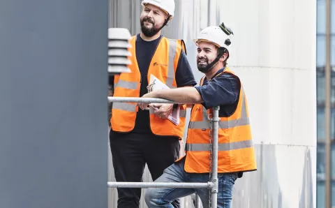 Two Equans district energy employees inspecting plant