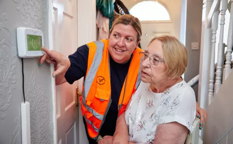 Equans employee helping resident in their home with energy savings