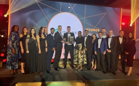 Group shot of the Equans team collecting one of the trophies secured at the Building the Future Awards Ceremony